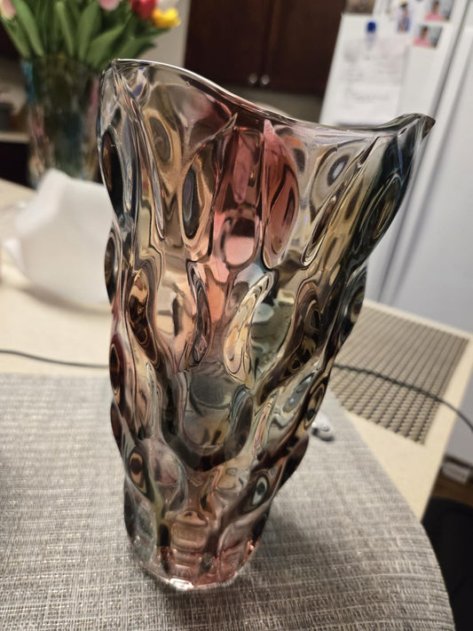 Decorative glass vase with a unique pattern on a textured surface