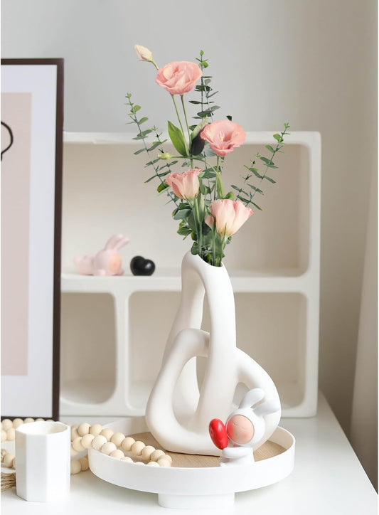Decorative vase with flowers on a white surface