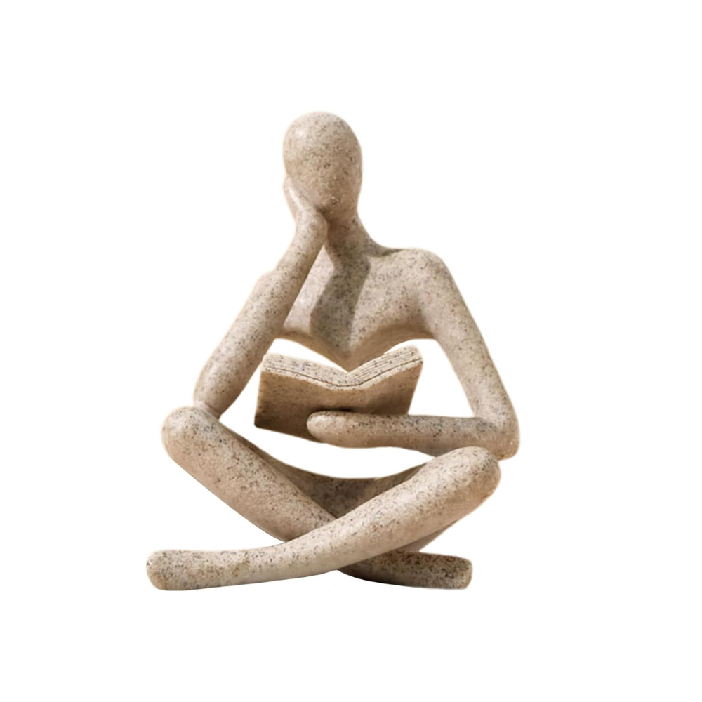 Abstract sculpture of a sitting figure on a white background