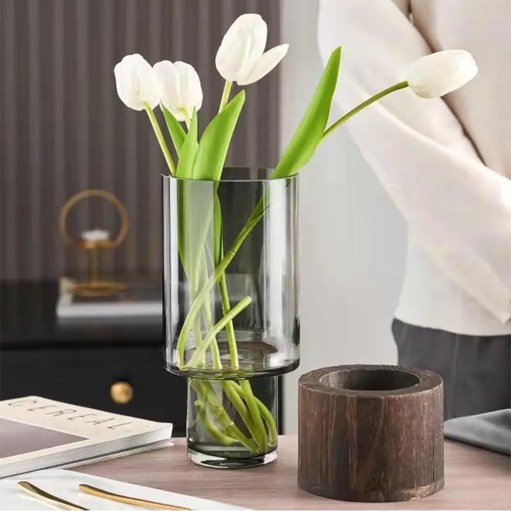Clear glass vase with white tulips on a table with a blurred background