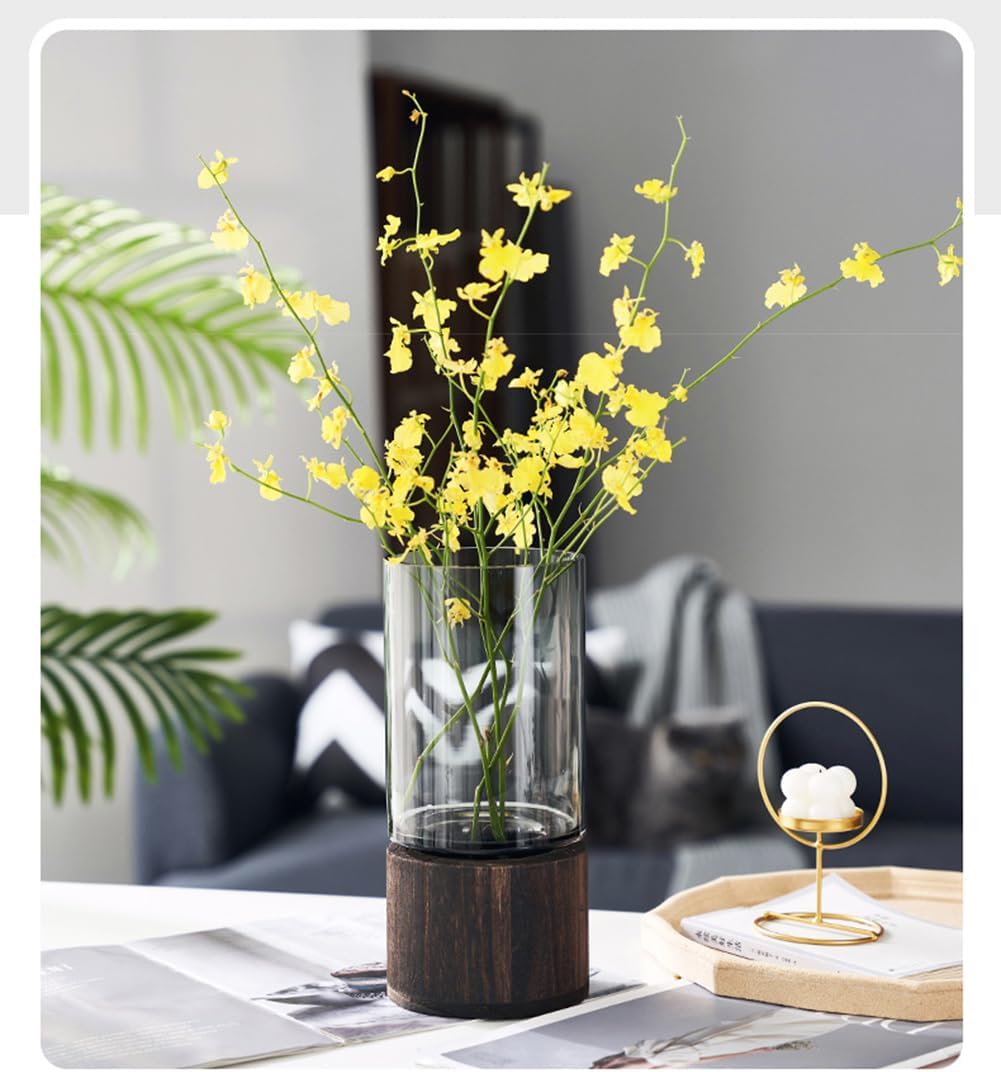 Clear vase with yellow flowers on a table in a modern living room setting