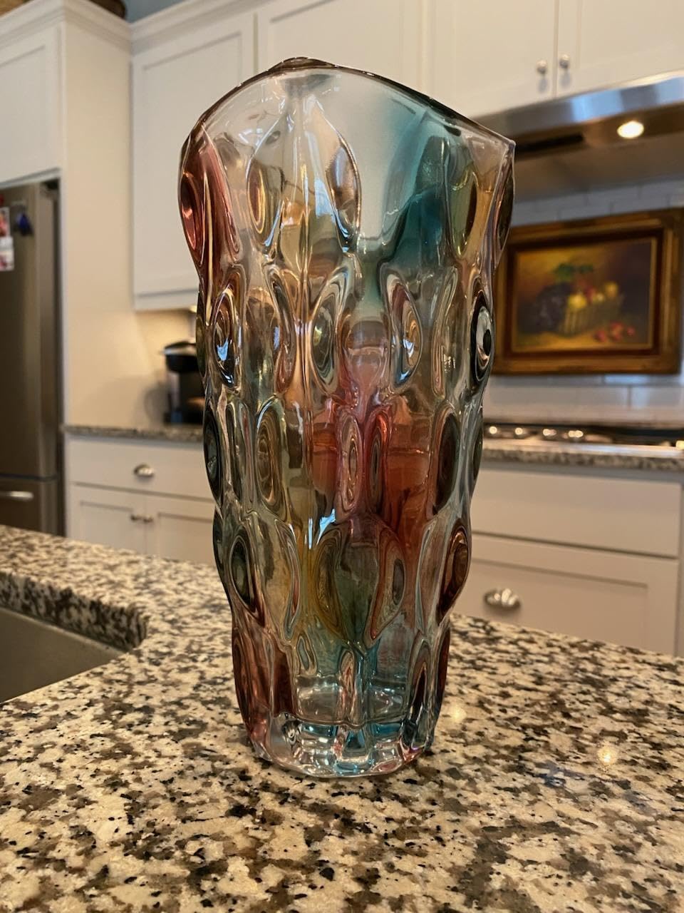 Decorative glass vase on a kitchen counter with a kitchen background