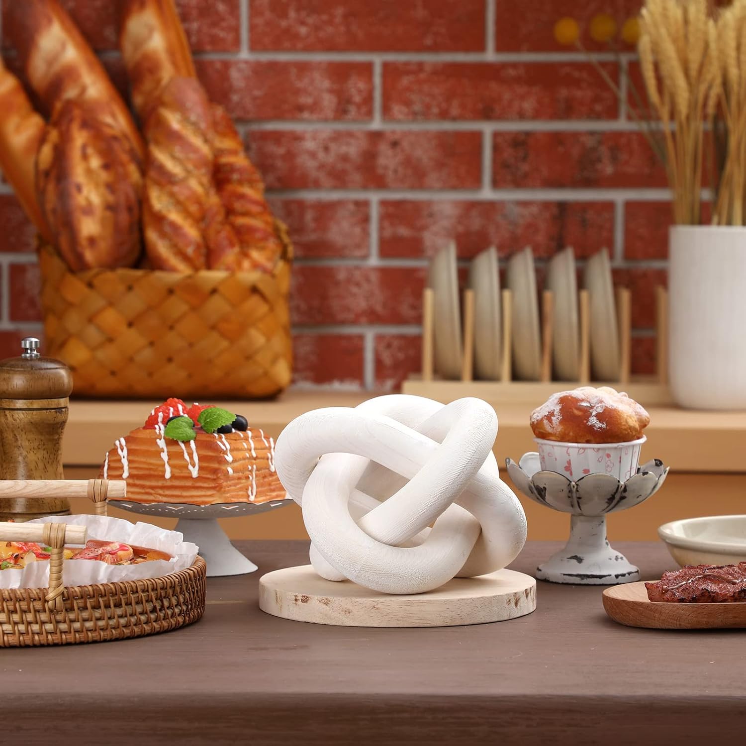 Decorative knot sculpture on a wooden stand with a rustic kitchen background
