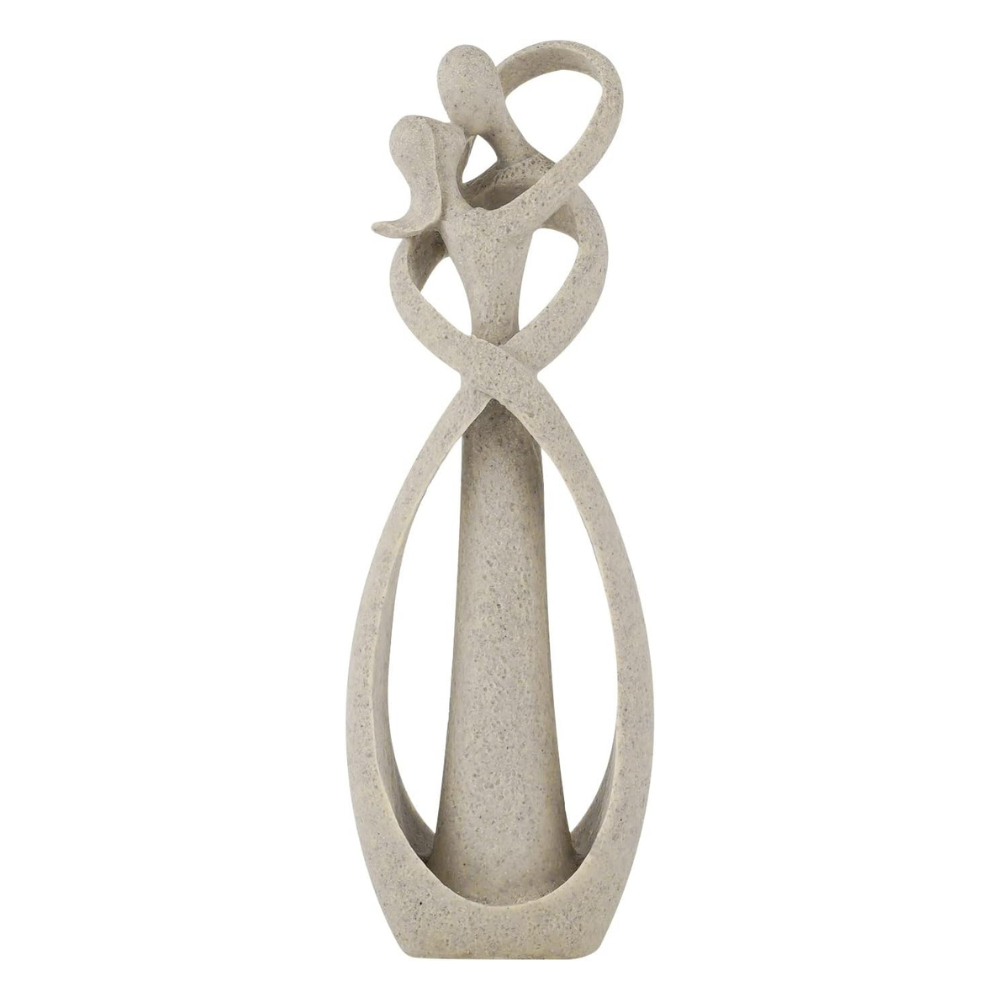 Decorative sculpture of two intertwined figures on a white background