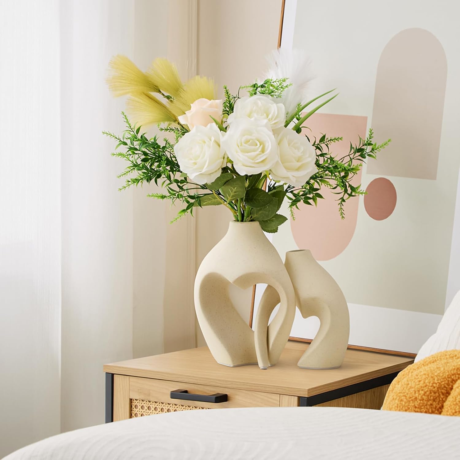Decorative vase with flowers on a bedside table in a bedroom setting
