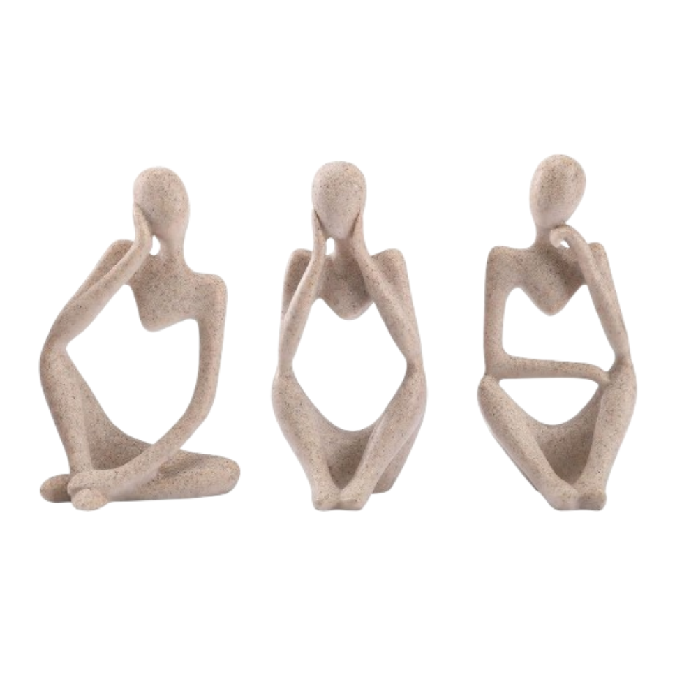 Three beige abstract figurines on a white background