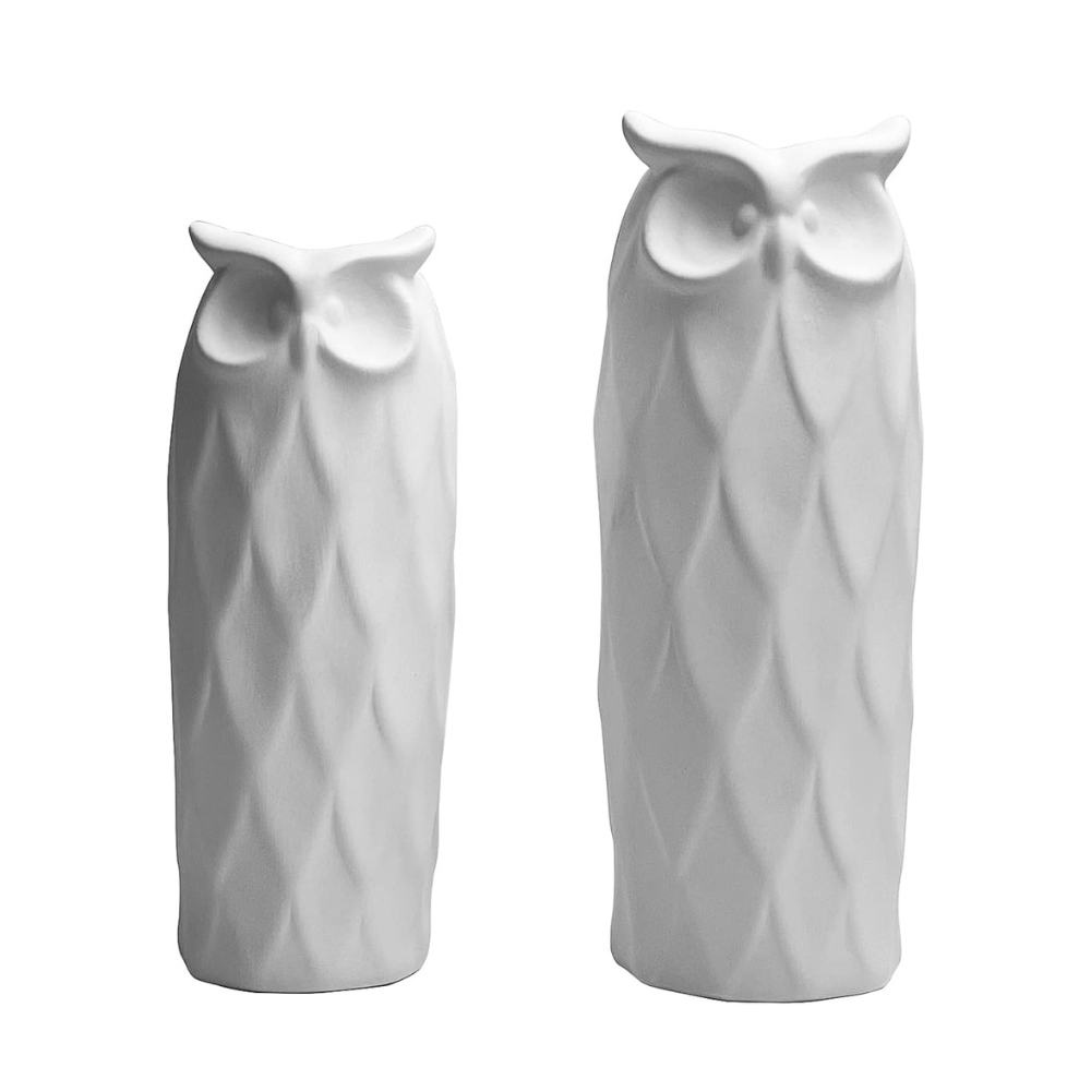 Two white owl-shaped vases on a white background