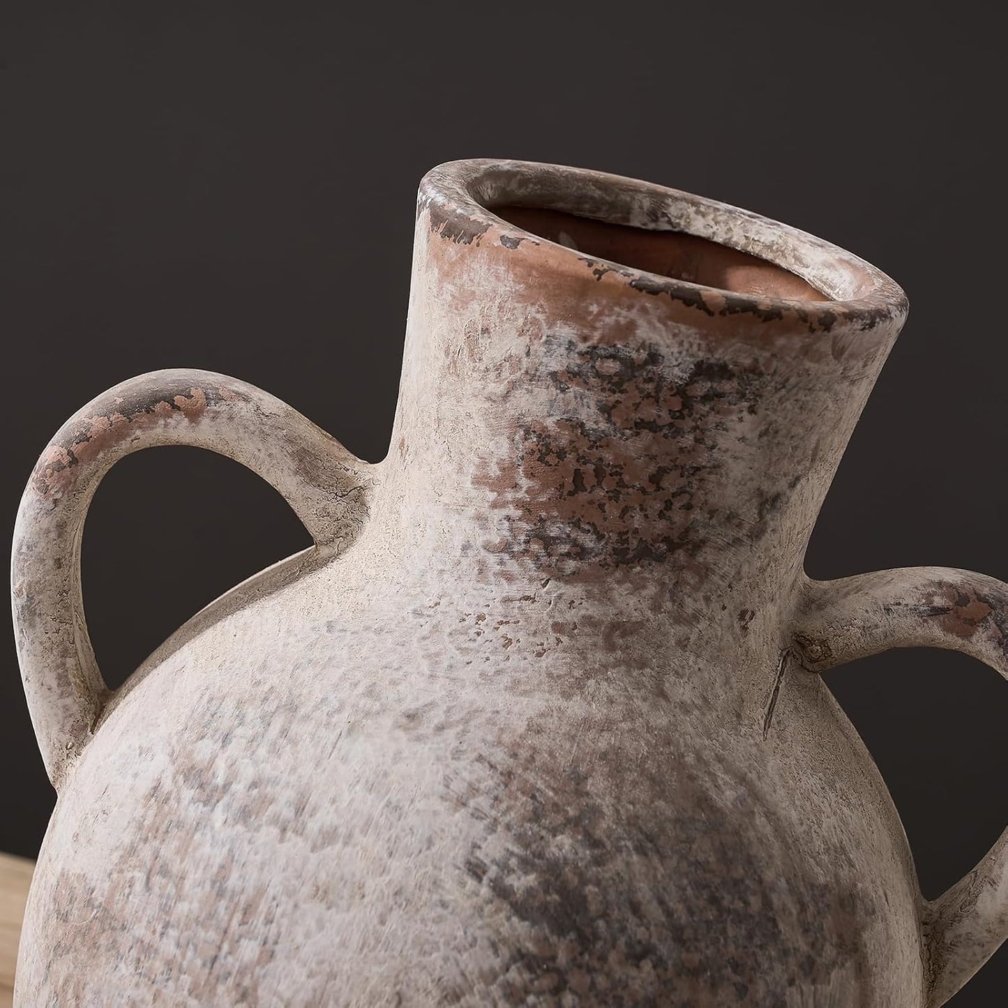 Vintage ceramic pitcher with a dark background