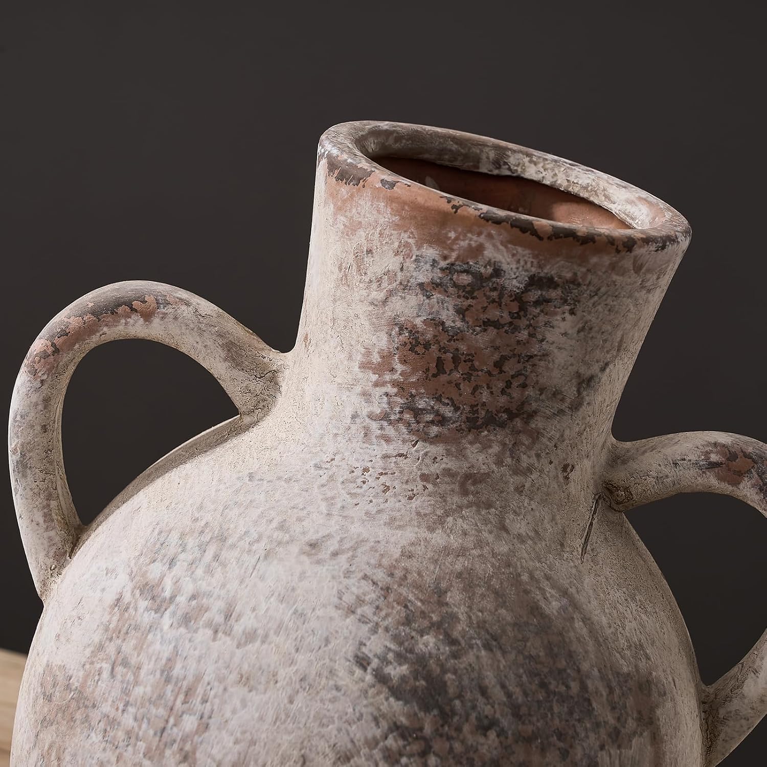 Vintage ceramic pitcher with a dark background