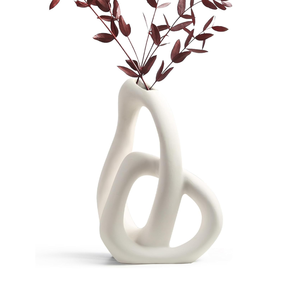 White abstract vase with a plant on a white background