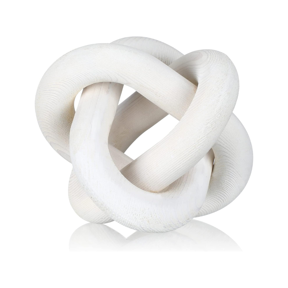 White ceramic knot sculpture on a white background