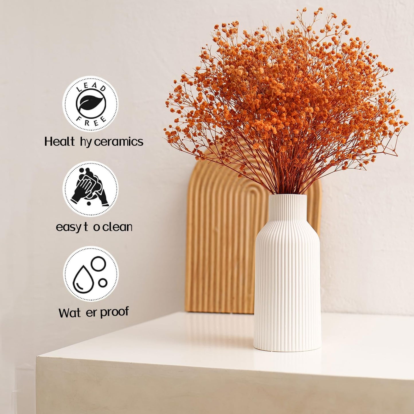 White vase with orange dried flowers on a white surface, with icons and text indicating features.